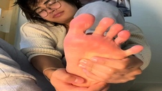 Sweet asian hottie with foot fetish doing footjob in POV