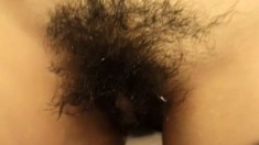 Little Lan has a bushy twat and vibrates her clit in the bathtub